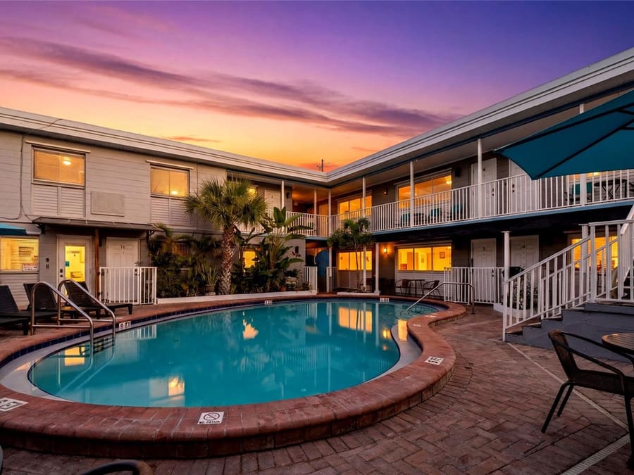 The Boutique Beach Retreat at 11965 Gulf Blvd, Treasure Island - 11-unit property with pool at sunset