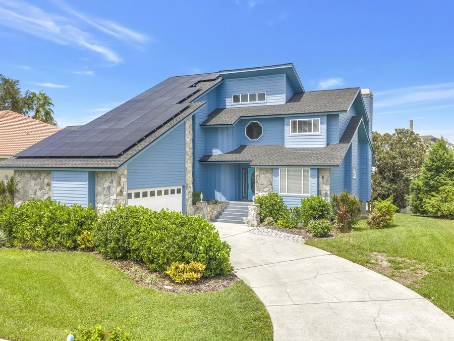 Blue two-story contemporary with owned solar at 2111 Harbour Watch Dr, Tarpon Springs