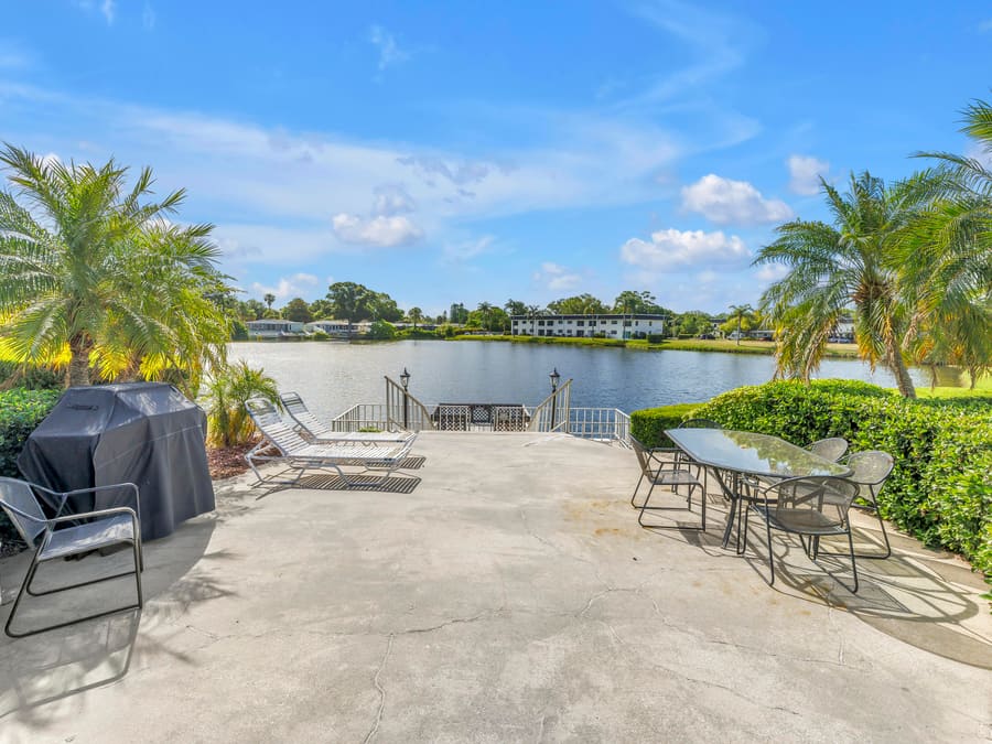 Waterfront patio seating overlooking the pond at Penthouse Groves, 1655 S Highland Ave